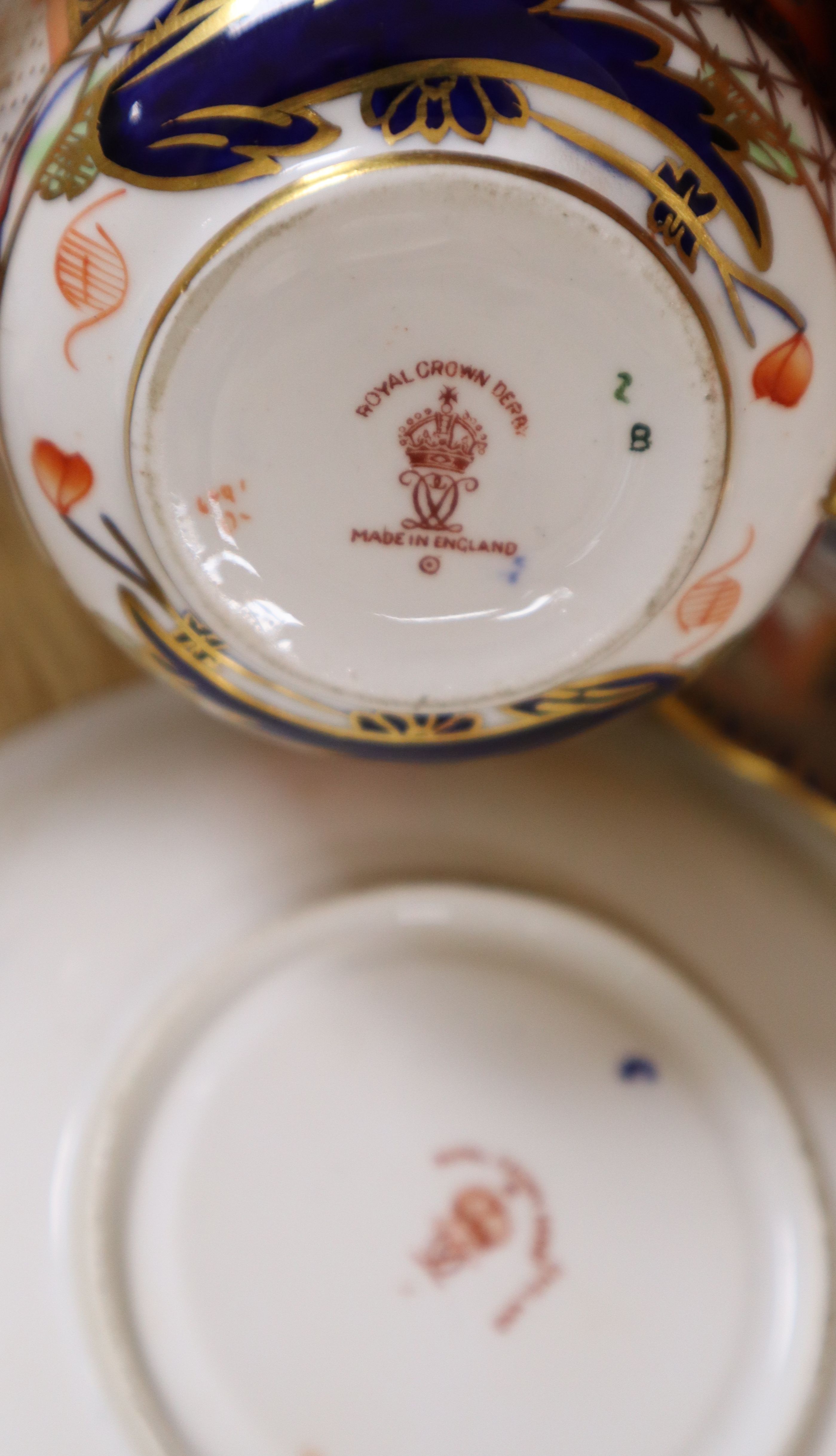 A collection of six Royal Crown Derby cups and saucers, a small square trinket dish and a miniature cup and saucer (16)